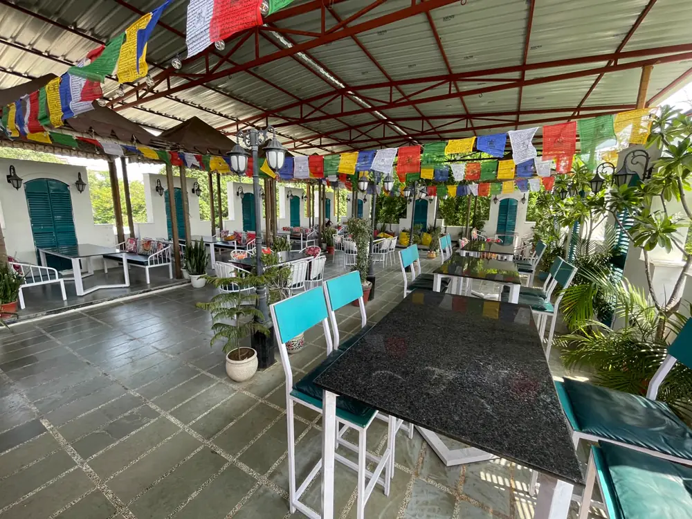 High tables and bar stools under the covered rooftop