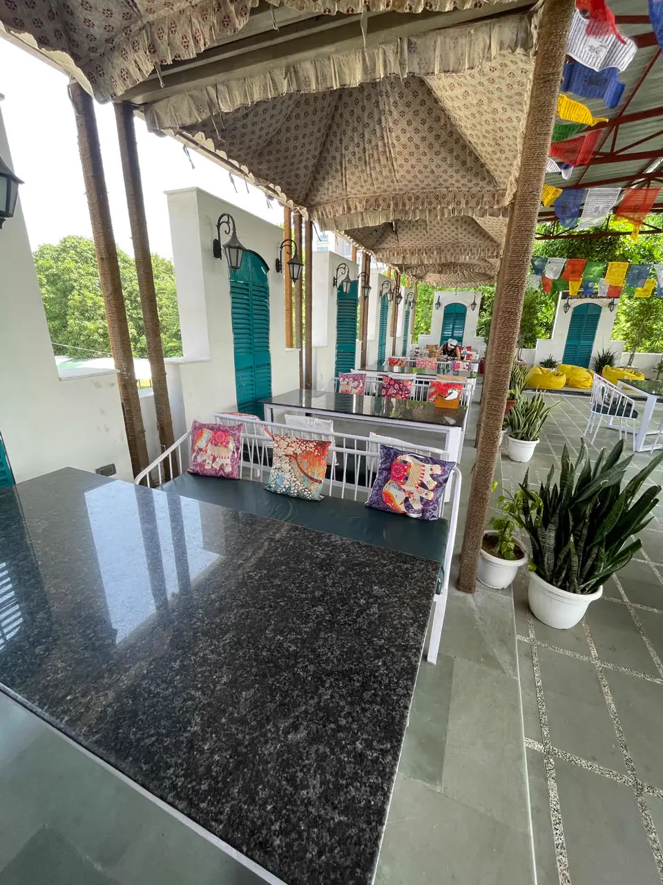Cushioned bench seating beneath printed canopies